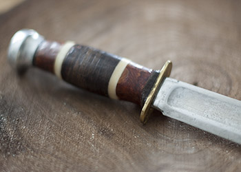 hunting knife with stacked leather, wood and bone handle